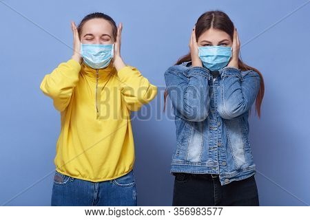 Horizontal Shot Of Young Caucasian Women Wearing Casual Clothing Covering Ears And Closed Eyes, Ladi