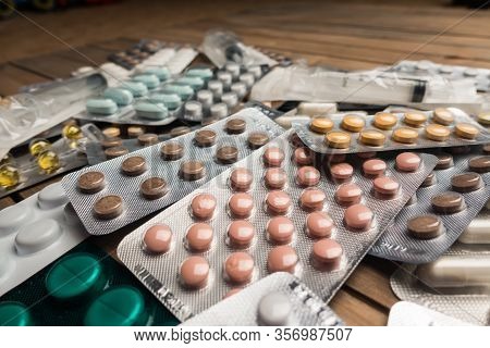Closeup Shot Of Different Pills On Table With Tablets , Pharmaceutical Industry Concept