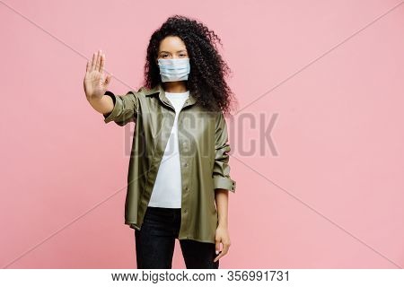 Horizontal Shot Of Afro American Woman Keeps Palm Towards Camera, Makes Stop Gesture, Tries To Preve