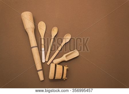 Wooden Kitchen Tools, Spoons On A Brown Paper Background. Concept Of Eco Tools, No Plastic. Ziro Was