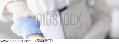 Focus On Practitioners Demonstrating Fist Bump Gesture With Hands In Gloves. Healthcare And Medicine