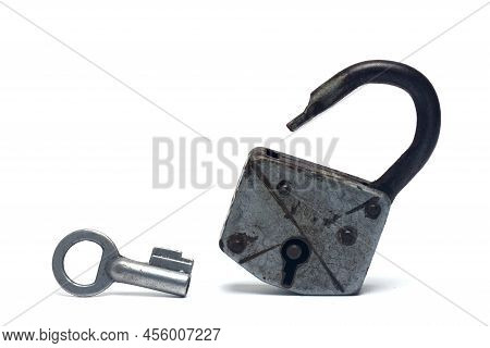 Closeup Of Silver Old Shackle U-lock On White Background With Silver Key Standing Next To It