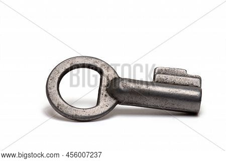 Close Up Of Silver Small Vintage Old Retro Key For Shackle U-locks On White Background