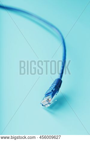 Blue Ethernet Cable Cord Patch Cord On A Blue Background With Free Space