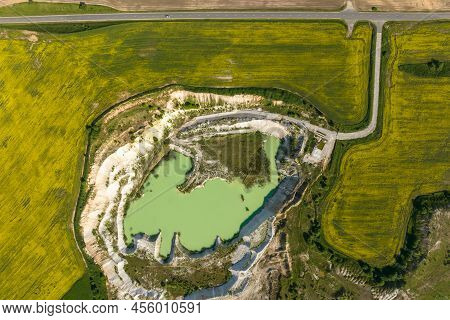 Ariel Top View Of An Old Flooded Lime Quarry With Turquoise Water