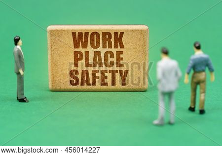 Security And Insurance Concept. On The Green Surface Are Figures Of People And A Sign With The Inscr