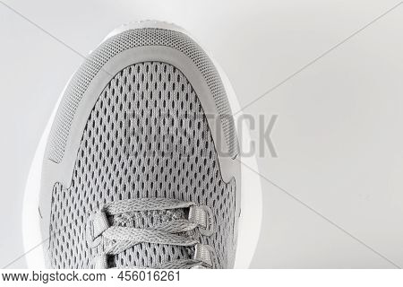 New Unbranded Running Sneaker Or Trainer On White Background. Men's Light Grai Sport Footwear. Close