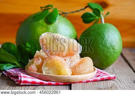 Pomelo Fruit On Wooden Background, Fresh Green Pomelo Peeled On Plate And Green Leaf Frome Pomelo Tr