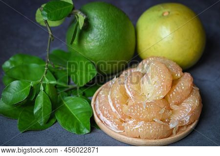 Pomelo Fruit On Plate And Dark Background, Fresh Green Pomelo Peeled On Plate And Green Leaf Frome P