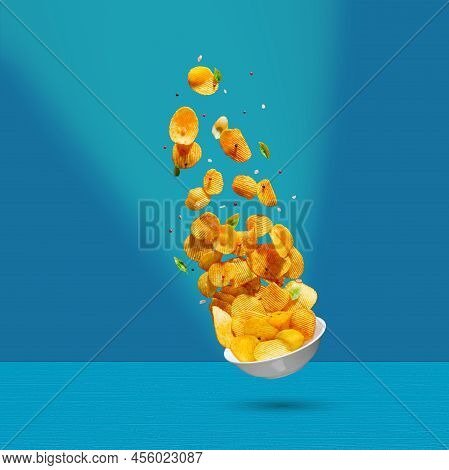 Potato Chips Falling Onto Plate On White Background. Advertising Concept. Levitation Flying Chips