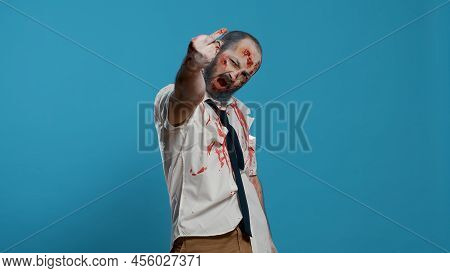 Evil Looking Scary Mindless Zombie Being Rude By Showing Middle Finger To Camera. Sinister Frighteni