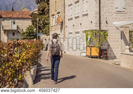 Man Tourist Enjoying Colorful Street In Old Town Of Perast On A Sunny Day, Montenegro. Travel To Mon
