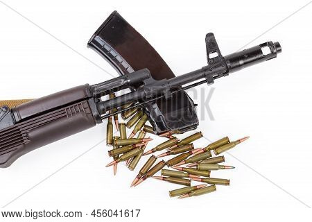 Front End Of Assault Rifle Against The Appropriate Rifle Cartridges In Magazine And On A Heap On A W