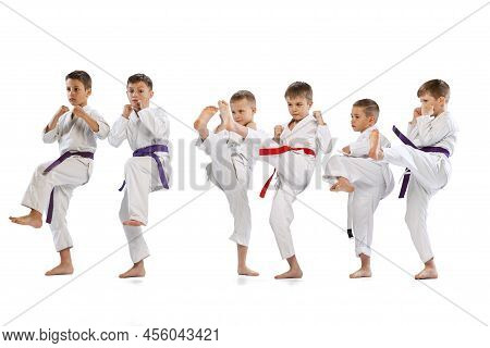 Sport Training Of 6 Little Kids, Beginner Karate Fighters In White Doboks Practicing Together Isolat