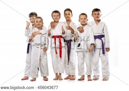 Portrait Of 6 Preschool Age Boys, Beginner Karate Fighters In White Doboks Standing Together Isolate