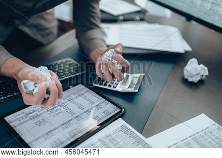 Serious Investors Have A Mad Crump Paper And Angry While Working  On The Desk.  Accounting And  Fina