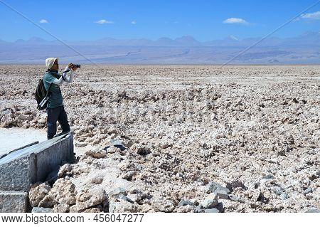 Traveler Taking Photos Of Salar De Atacama, An Extensive Chilean Salt Flat At The Altitude Of 2,305 