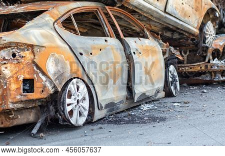A View Of Burnt-out Cars After Rocket Attacks By The Russian Military. War Of Russia Against Ukraine