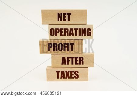Business Concept. On A White Surface Are Wooden Blocks With The Inscription - Net Operating Profit A