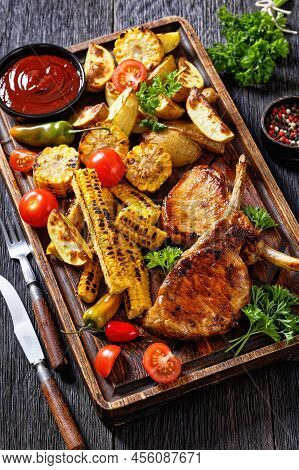 Bbq Tomahawk Pork Chops, Bone-in Ribeye With Grilled Corn Disks And Corn Ribs, Wedges Potatoes, Fres