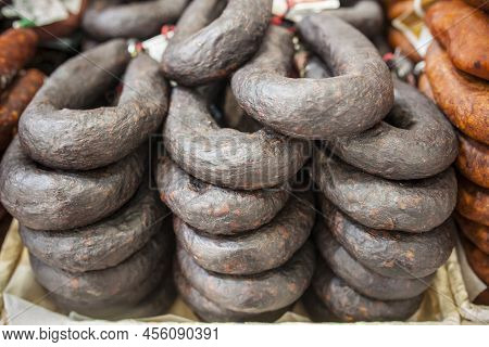 Black Sausage Or Black Iberian Morcilla Pile Displayed At Street Market Stall. Closeup