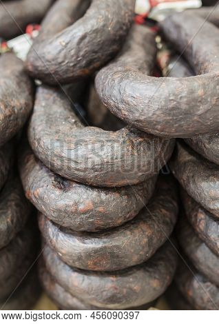 Black Sausage Or Black Iberian Morcilla Pile Displayed At Street Market Stall. Closeup