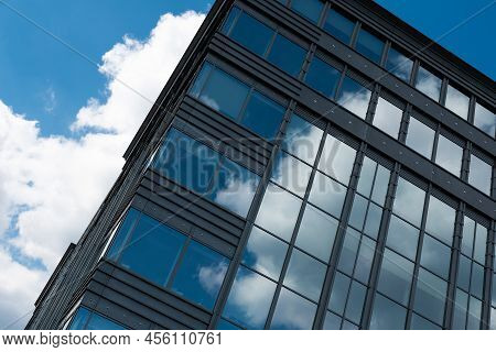 Boitsfort, Brussels Capital Region - Belgium - 05 20 2020 Blue Clouds Reflecting In The Windows Of A