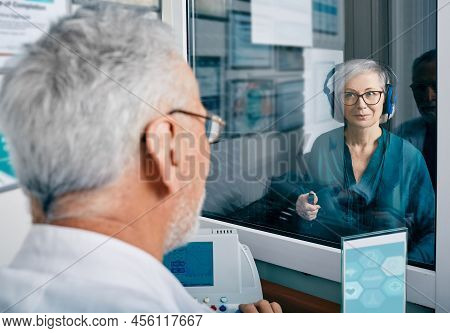 Senior Woman Receiving Hearing Exam At Audiology Clinic. Audiometry, Hearing Check-up