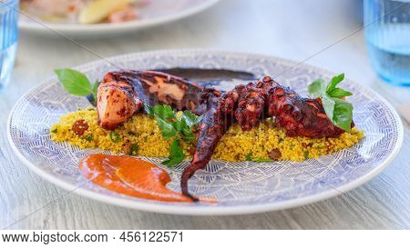 Aromatic Couscous With Sweet Raisins And Grilled Octopus Tentacles
