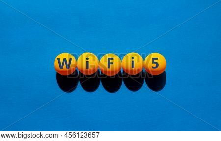 Wifi 5 Symbol. The Concept Word Wifi 5 On Orange Table Tennis Balls. Beautiful Blue Table, Blue Back