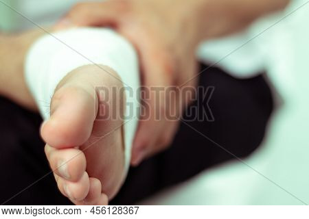 Injury Foot. Young Man With Injured Foot. Wrapped With Bandages,caused By The Impatience - Image
