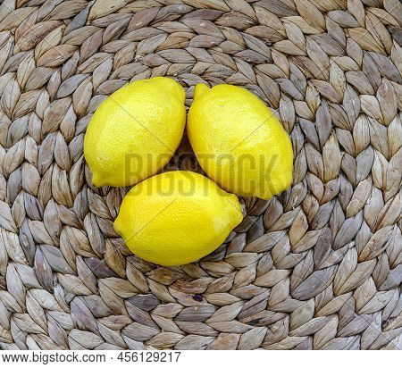 Fresh Autumn Three Yellow Lemons Situated On The Natural Cruft Beige Rattan Structured Floor At The 