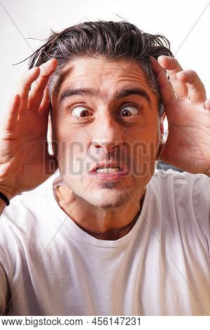 Young Man In White T-shirt On White Background Isolated, Crazy Expression On Face. Simple And Natura