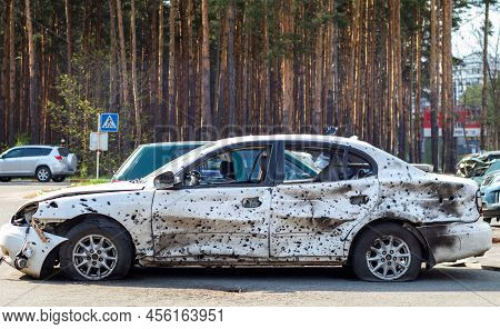 Shot, Damaged Cars During The War In Ukraine. The Vehicle Of Civilians Affected By The Hands Of The