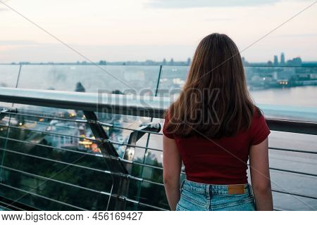 A Teenage Girl Stands On An Observation Platform On The Banks Of The Dnieper River. View From The Ba
