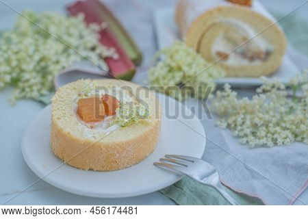Sweet Home Made Bisuit Roll With Rhubarb And Elderflower On A Table