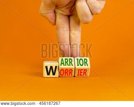 Be Warrior Not Worrier Symbol. Concept Words Warrior And Worrier On Wooden Cubes. Businessman Hand. 