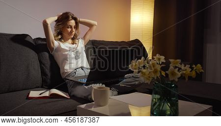 Tired Freelancer Finishes Her Online Work On Laptop. Woman Works Night Late. Female Exausted Facial 