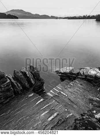 Black And White Stunning Landscape Image Of Loch Lomond And Snowcapped Mountain Range In Distance Vi