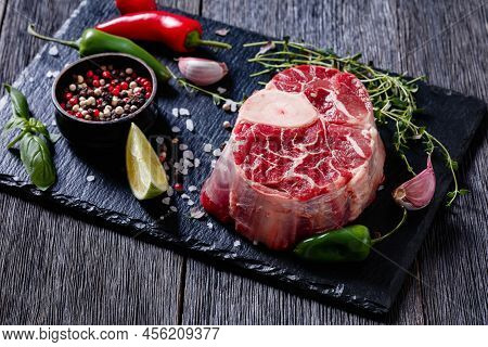 Uncooked Osso Buco, Veal Shank Steak With Marrowbone On Black Stone Board With Peppercorns, Fresh Th
