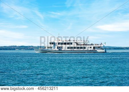 Bardolino, Italy - May 26, 2021: White Ferry Boat With Tourists On The Move On Lake Garda In Front O