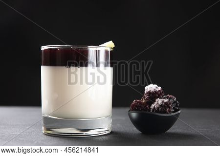 Glass With Dessert Pana Cotta On A Black Background With Berries