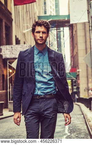 Raining, Blurry, Moody Feel. European Businessman Traveling In New York. Wearing Blue Suit, A Guy Wi
