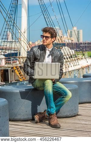 Traveling, Working In New York. Wearing Black Leather Jacket, Blue Jeans, Brown Boot Shoes, Sunglass