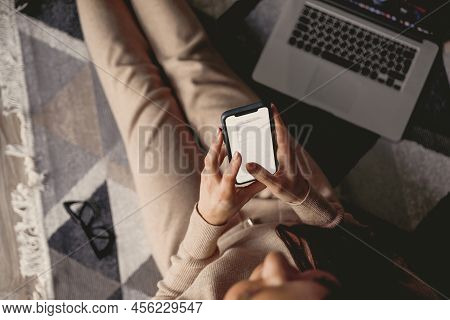 Woman Using Phone Sitting On Floor. Payment.  Online Shopping Concept.concept Of Blogging. Top View.