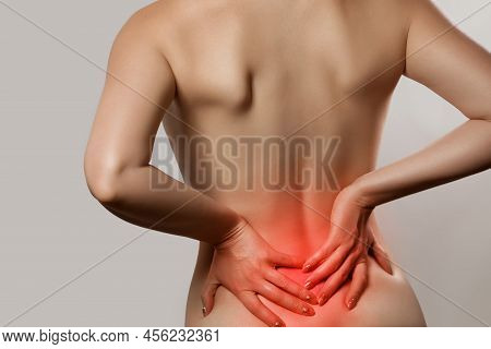 Woman Having Backache, Pain Back Isolated On Gray Background. Scoliosis. Spinal Cord Problems On Wom