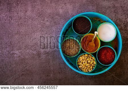 Indian Spice Box On Wooden Background With Copy Space,cardamom, Turmeric, Chilli Powder, Salt,mustar
