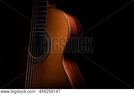 Classical Guitar On A Black Background With Copy Space