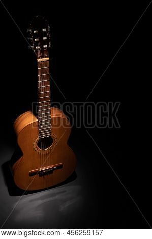 Classical Guitar On A Black Background With Copy Space