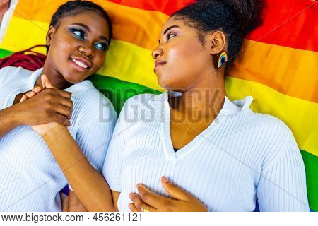 Brazilian Lesbian Couple In White Dress Spending Time Together Celebrating Engagement In Summer Park